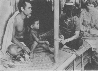 An Ethnographic Interview. Bateson and Mead's Balinese secretary, I Made Kaler, takes notes during Mead's talk with Nang Karma and his son, I Gata. Bajoeng Gede, Bali; 1937; Gregory Bateson, photographer